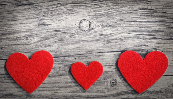 Red hearts on a wooden background Royalty Free Stock Photos
