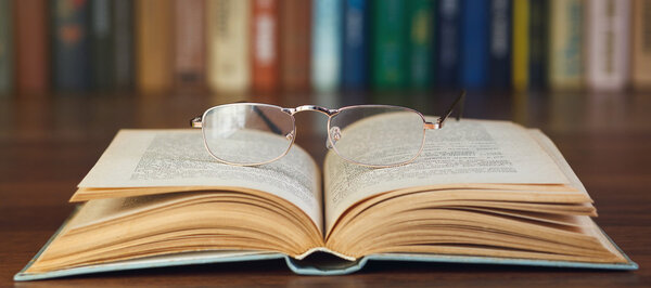 Glasses on open book