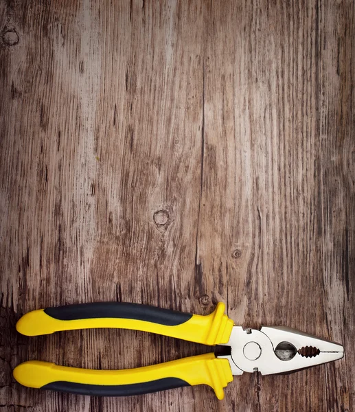 Handtool pliers on wooden doard — Stock Photo, Image