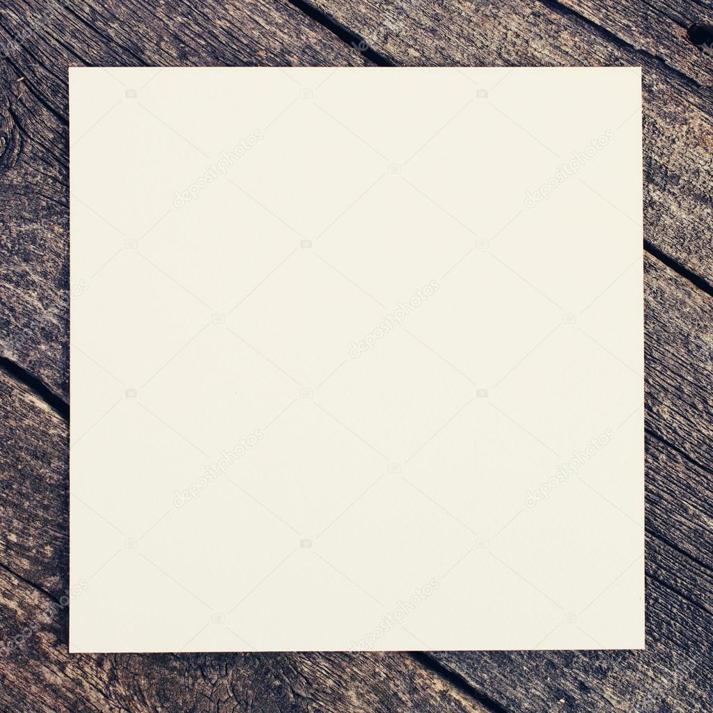 wooden background with blank paper