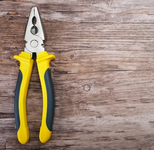 Pliers on wooden background — Stock Photo, Image