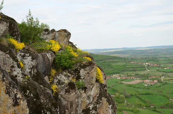Volcanic rocks above village — Stock Photo, Image