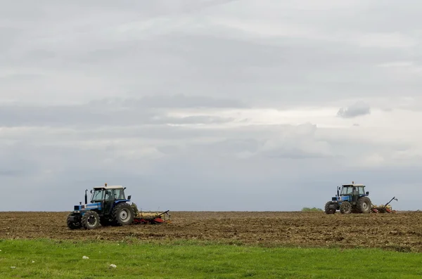 Two wheeled tractors sow a field of wheat — Stock Photo, Image