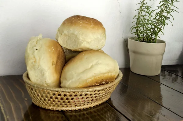 Small  loaf fresh household bread in the breadbasket — Stock Photo, Image