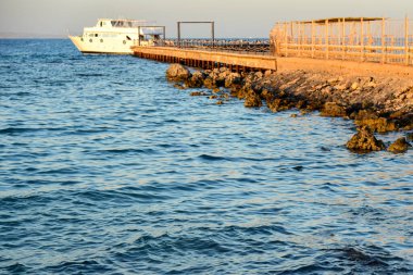 Akşamları deniz rıhtımında beyaz yat, bulanık..