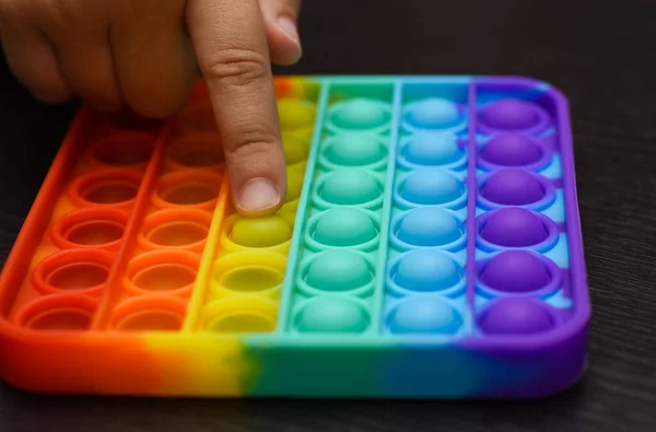 Child Finger Presses Ball Color Pop — Stock Photo, Image