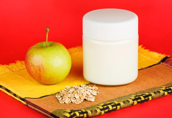 Jar with yogurt isolated on red background — Stock Photo, Image