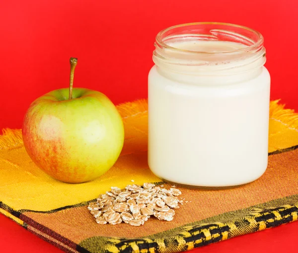 Jar with yogurt isolated on red background — Stock Photo, Image