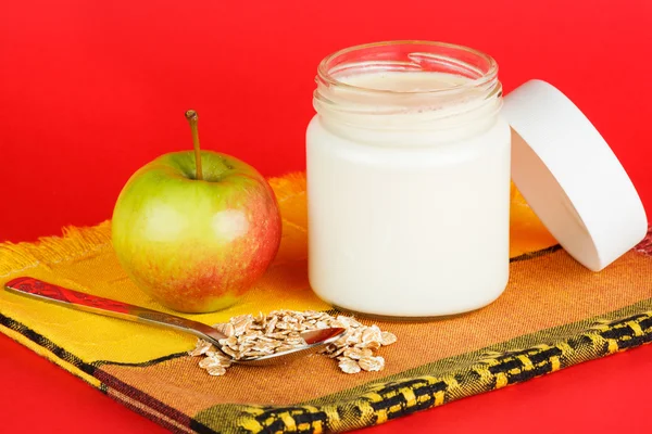 Jar with yogurt isolated on red background — Stock Photo, Image