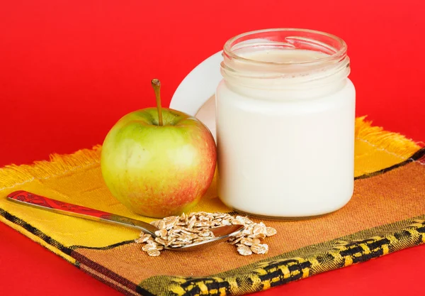 Jar with yogurt isolated on red background — Stock Photo, Image