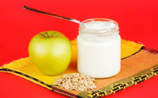 Jar with yogurt isolated on red background — Stock Photo, Image