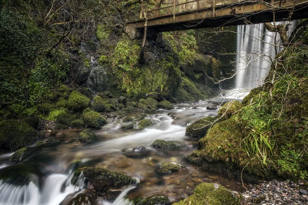 Waterfall under an old brigdge — Stock Photo, Image