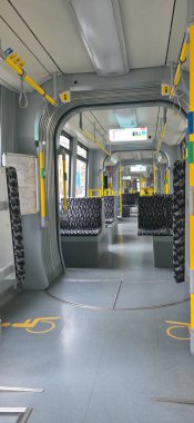 Berlin, Germany - July 24, 2025: . Interior view of a modern tram featuring empty seats and bright overhead lighting