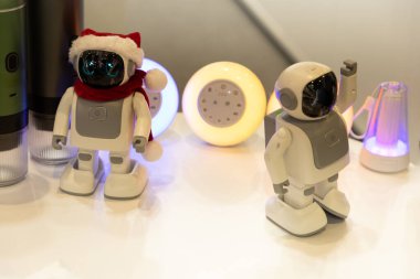 Berlin, Almanya - 09 Eylül 2025: IFA.Berlin. İki Noel temalı robot şenlikli aksesuarlarla süslenir ve renkli ışıklarla çevrilidir.