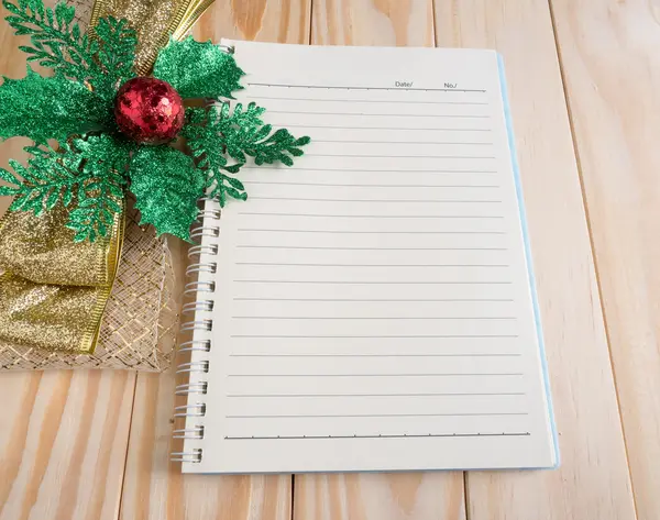Blank notebook with chrismas ribbon on wood background — Stock Photo, Image