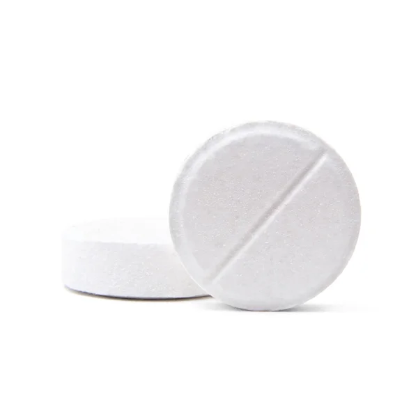 Macro shot of two medical round pills isolated on white Stockafbeelding