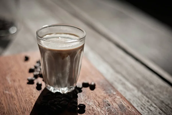 stock image Dirty coffee glass, cold milk topped with hot espresso coffee sho