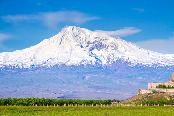 Khor Virap monastery in front of Mount Ararat viewed from Yerevan, Armenia. This snow-capped dormant compound volcano described in the Bible as the resting place of Noah's Ark.