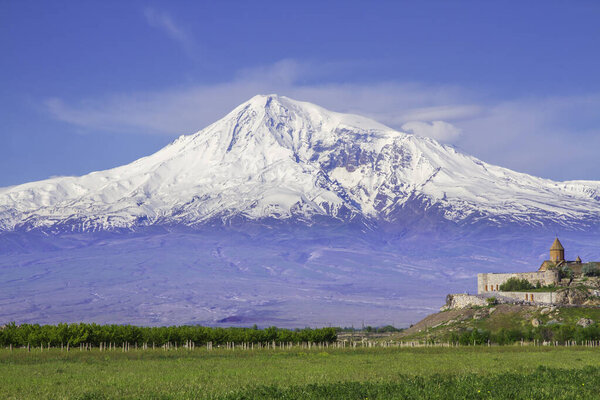 Khor Virap monastery in front of Mount Ararat viewed from Yerevan, Armenia. This snow-capped dormant compound volcano described in the Bible as the resting place of Noah's Ark.