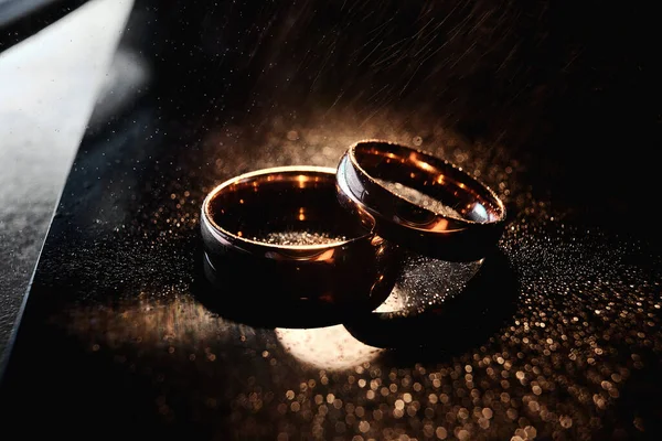 Zarif alyanslar altından yapılır. Yakın plan, makro. Koyu arkaplan