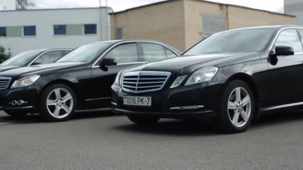 Minsk, Belarus - September 17, 2020: Prestigious black Mercedes cars drive in a row and demonstrate driving dynamics and power. Side view. Slow motion — 비디오