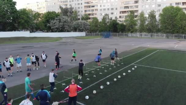 Misk, Belarus - August 15, 2020: Drone footage of the training process of football players at the city Stadium at the summer day — 비디오