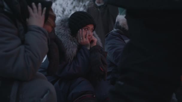 Murmanszk, Oroszország - 2021. január 10: Egy fiatal lány ül egy férfi mellett a téli erdőben. Elmélkedés és nyugalom fogalma — Stock videók