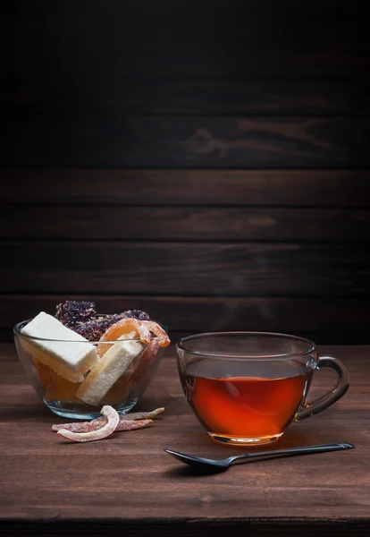 Glass cup of tea and sweets — Stock Photo, Image