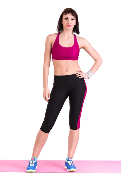 Young smiling woman makes exercise, full length portrait isolated over white — Stock Photo, Image