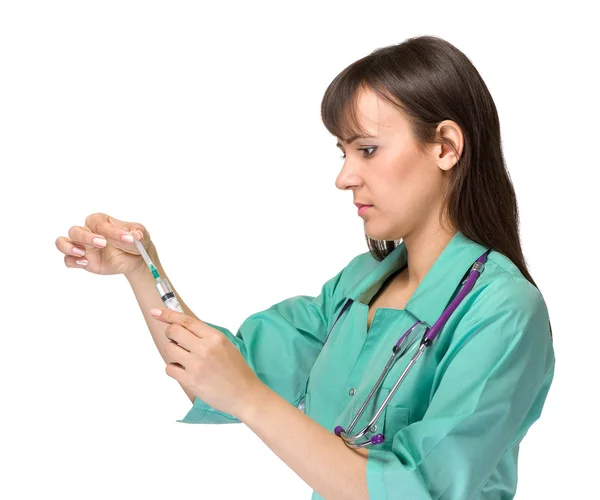 Doctor or nurse in lab coat holding syringe. Isolated over white. Stock Photo