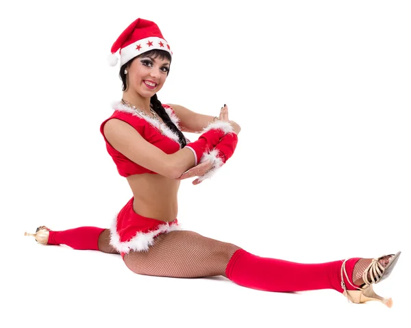 Christmas fitness kvinna gör den splittring som bär santa, isolerad på vit bakgrund. — Stockfoto