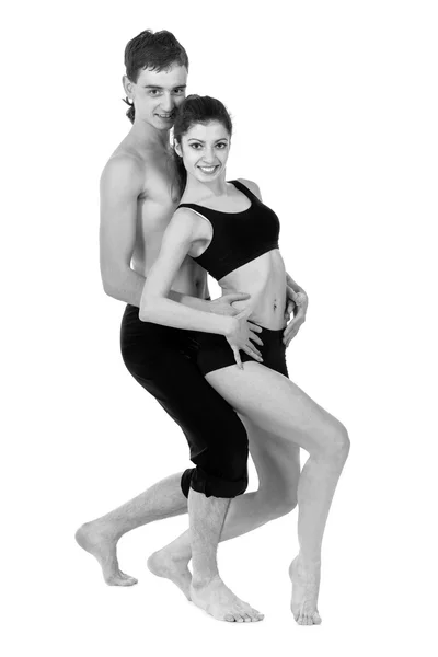 Portrait incolore de couple homme et femme faisant de l'exercice de fitness dansant sur fond blanc — Photo