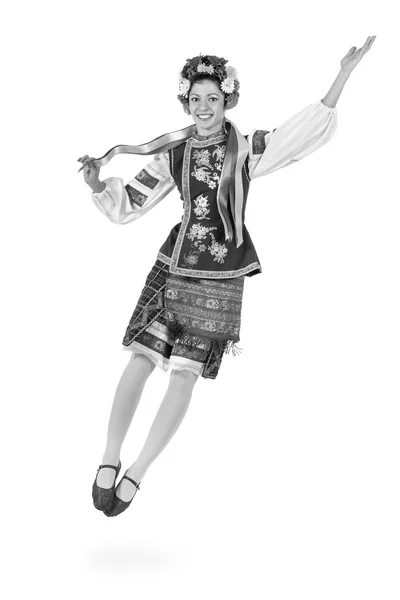 Colorless portrait of dancing girl in polish national traditional costume jumping — Stock Photo, Image