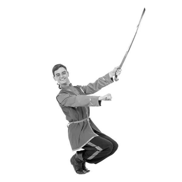 Colorless portrait of Russian cossack dance. Young dancer posing with sword — Stock Photo, Image