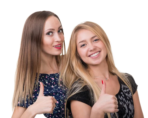 Two young women showing thumbs up, isolated over a white Stock Image