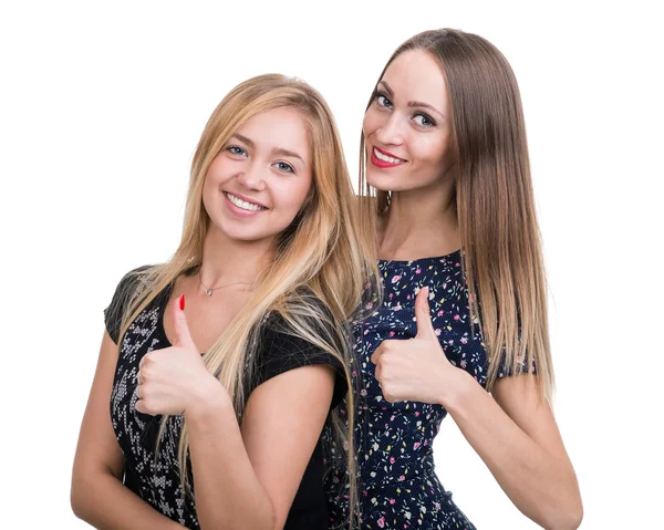 Twee jonge vrouwen tonen duimen omhoog, geïsoleerd op een witte — Stockfoto