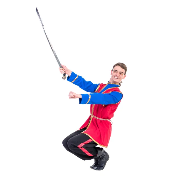 Ruský tanec Kozák. Mladý tanečník pózuje s mečem — Stock fotografie