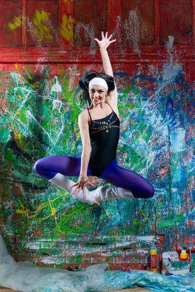 Sexy girl jumping of variegated background — Stock Photo, Image