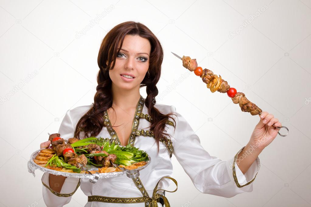 Waiters carrying plates with meat on white background