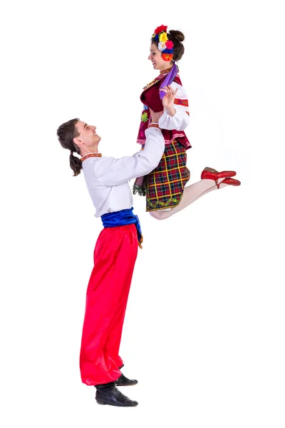 Beautiful dancing couple in ukrainian polish national traditional costume clothes jumping, full length portrait isolated — Zdjęcie stockowe