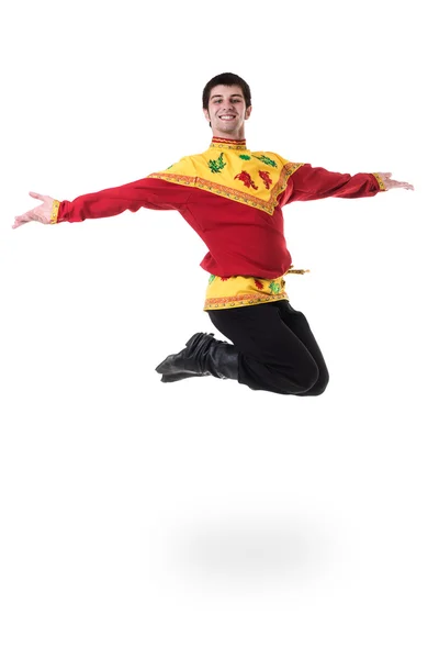 Young man wearing a folk russian costume jumping against isolated white with copyspace — Stock Photo, Image