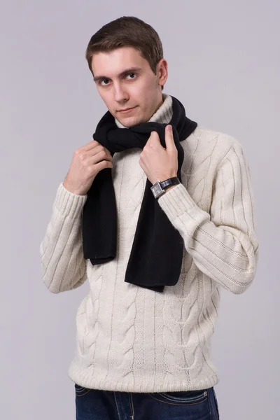 Man in winter knitted clothes standing with arms folded isolated on gray — Stock Photo, Image
