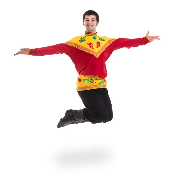 Jonge man draagt een folk Russische kostuum springen tegen geïsoleerde Wit met copyspace — Stockfoto