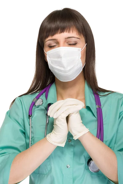 Praying female medical doctor with mask isolated — Stock Photo, Image