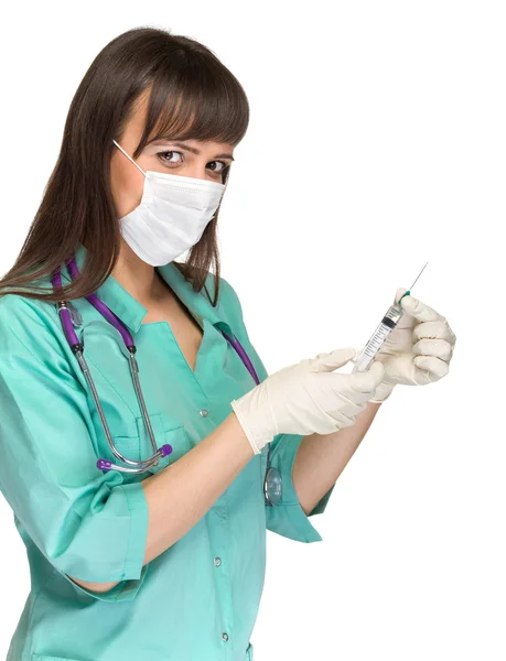 Doctor or nurse in face mask and lab coat holding syringe. Isolated over white. — Stock Photo, Image