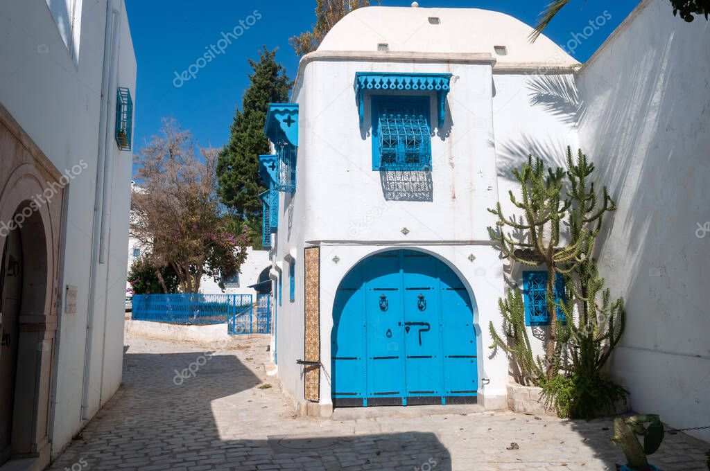 Old white buildings on a street in Sidi bou Said, Tunisia.