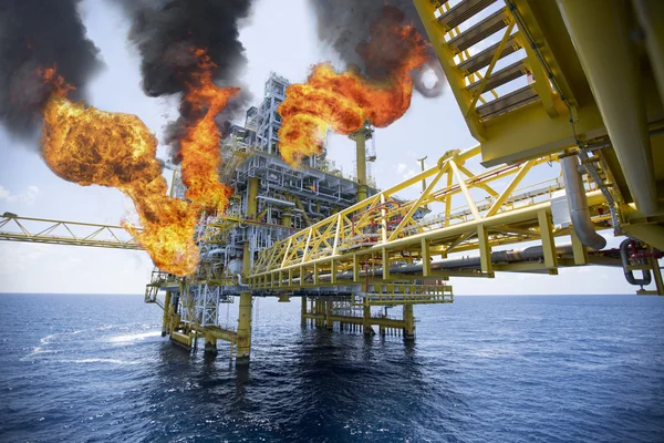 offshore oil and gas fire case or emergency case in warm picture style, firefighter operation to control fire on oil and gas production platform, offshore worst case and can't control fire, man overboard.