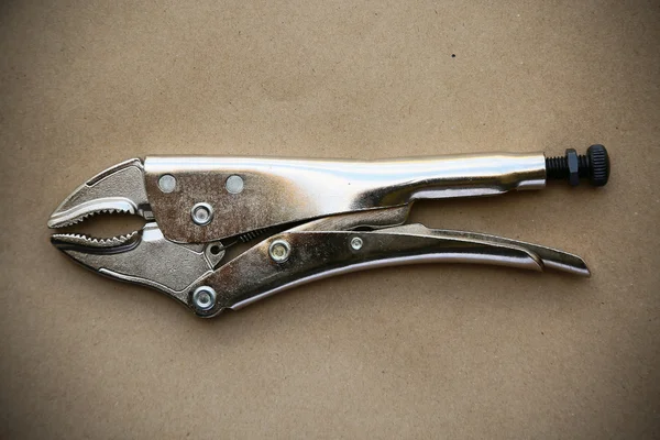 Close up locking pliers on wooden background, Hand tools in work shop. — Stock Photo, Image