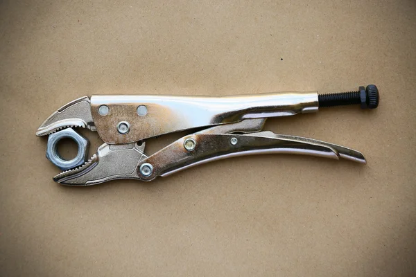 Close up locking pliers on wooden background, Hand tools in work shop. — Stock Photo, Image