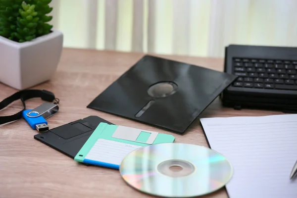 desk with note ,floppy disk A, floppy disk B and memory drive in home office, private office and modern desk in modern life, online market and planning for work, document and paper on desk.